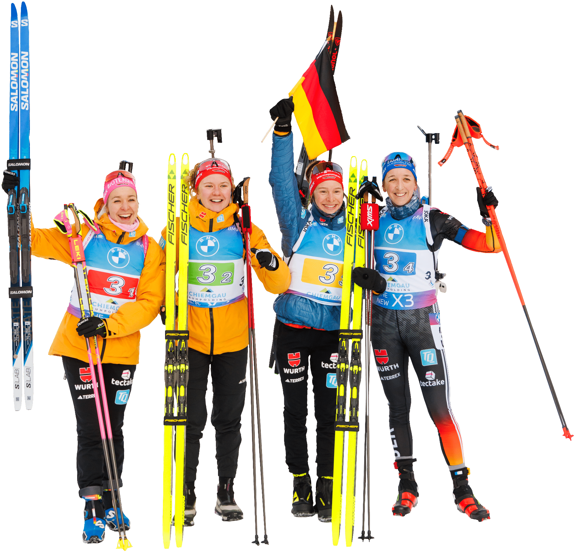 Vier deutsche Biathletinnen der Frauenstaffel feiern mit Skiern und Deutschlandfahne.
